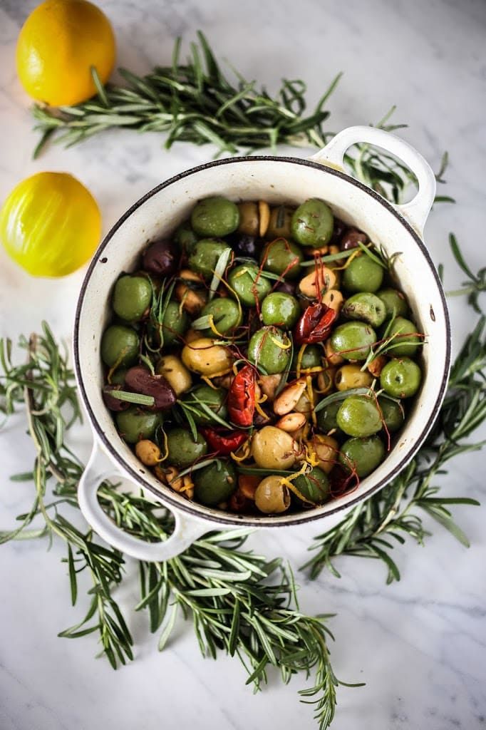Warm Marinated Olives with Lemon Zest, Rosemary, Garlic and Almonds from https://www.feastingathome.com/