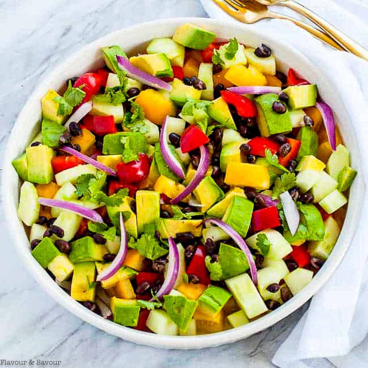 Tomato Avocado Black Bean Salad with Cilantro Lime Dressing from https://www.flavourandsavour.com/